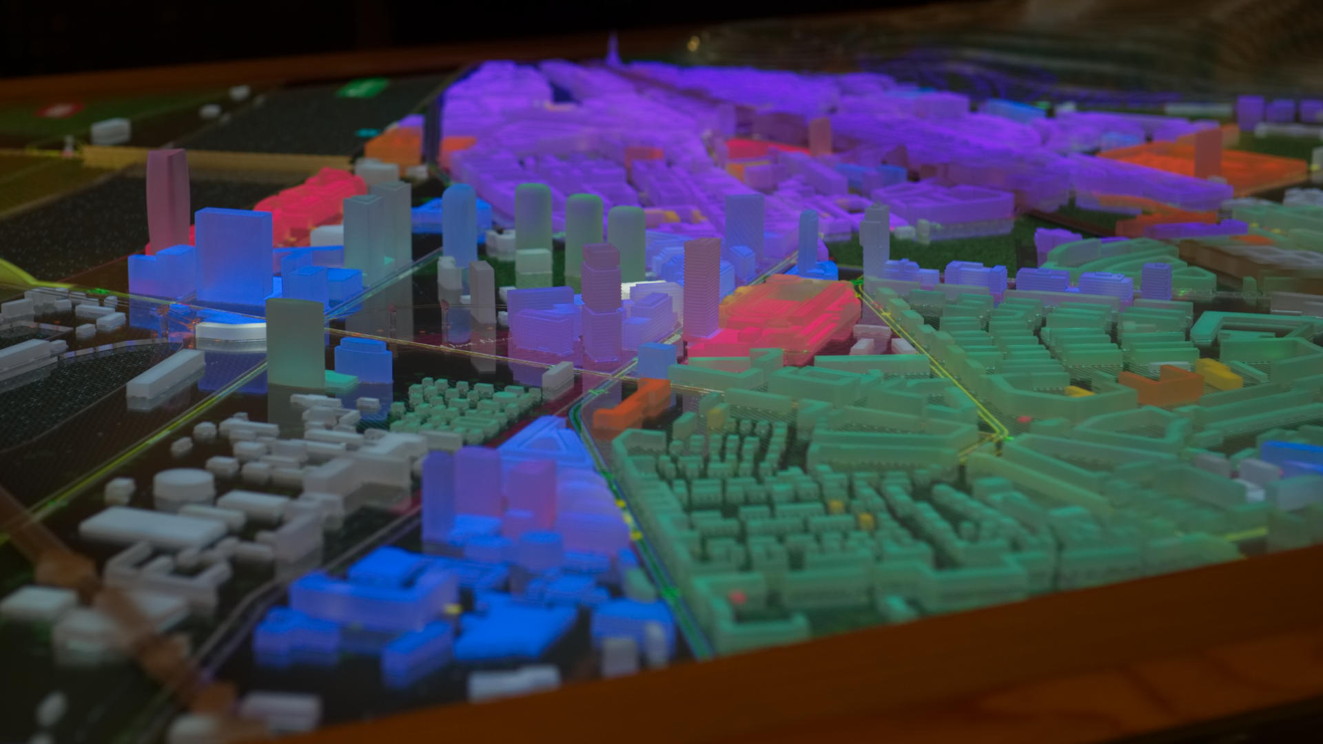 a photo detail of a region of the model with multiple urban elements highlighted mostly in blue, green and red