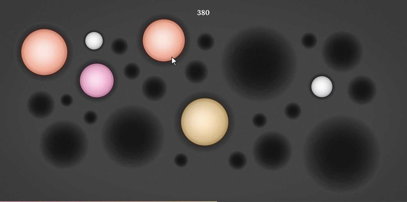 A screen with a group of orange, pink and yellow circular gems on gray background