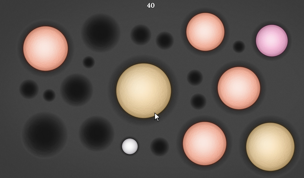 A screen with a group of orange, pink and yellow circular gems on gray background