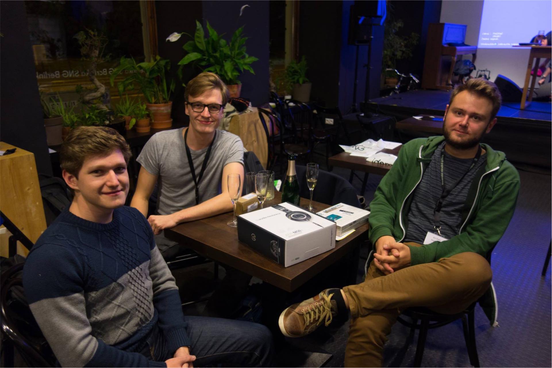 3 people sitting around a table in a restaurant where the hackathon took place