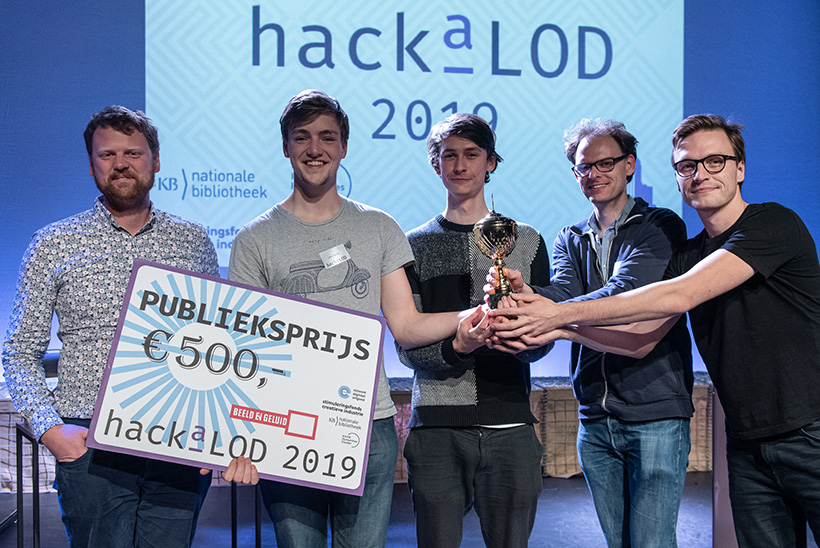 A photo of the ExpLOD team holding the audience prize trophy